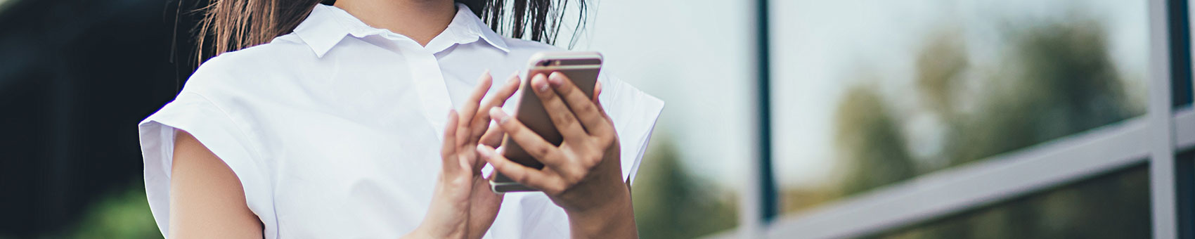 Woman using mobile app to access Moodle LMS